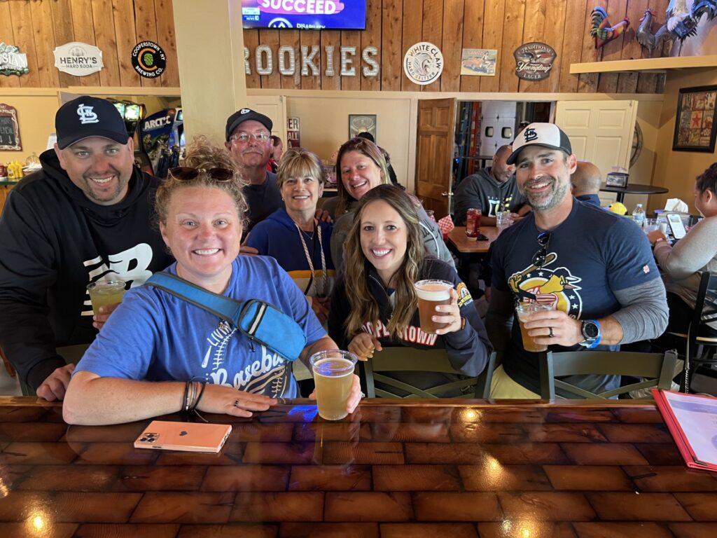 Group of friends smiling at the bar with drinks